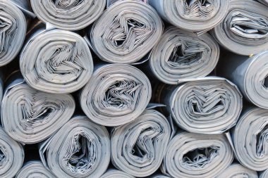 Gray Plastic rolls stacked in a disorderly manner, creating a sound of roller paper clipart