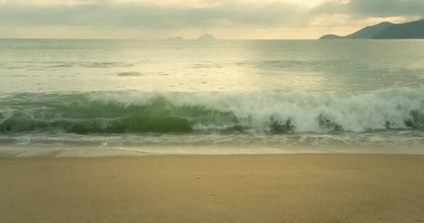 亚洲海滩背景 阳光在沙滩上的波纹 巨大的太阳从云后升起 巨大的山与地平线和海岸相接 — 图库视频影像