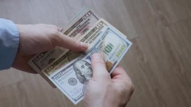 Amerikan Doları 'nın faturalarını sayan ya da nakit ödeme yapan eller. Yatırım, başarı, finansal beklentiler veya kariyer ilerlemesi kavramı.