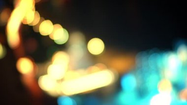 Yağmurdan sonra gece yarısı sokak lambaları soyut ışık arkaplan parçacıkları. Çok renkli ışınların hareketi. Beyaz-mavi-sarı-kırmızı renkli ışıkların soyutlanması neon ışıkla yeniden şekillendirilir.