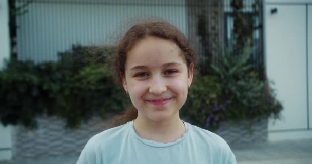 Hoş Bir Gülümseme Takınan Mutlu Okul Kızı Kameraya Bakıyor Gülümsüyor — Stok video