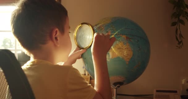 Schoolchild Morning Light Sits Table Home Looking Globe Magnifying Glass — Stock Video