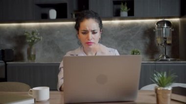Yorgun ve genç bir kadının portresi başını tutarak kafasında şiddetli bir ağrı hisseder. Evde bilgisayar başında çalışmaktan yorgun düşmüş bir kadın şiddetli baş ağrısı hisseder. Baş ağrısı, görsel yorgunluk ve göz yorgunluğu.