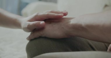 Büyükannem küçük torunumun elini tutuyor. Yaşlı annesiyle el ele tutuşan bir torun. Yaşlı bir anne ve torununun elleri. 4K