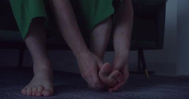 Adam ayağını ovuyor çünkü ayaklarına acı veriyor..
