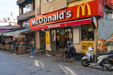 ISTANBUL - JAN 15: Facade of McDonald restaurant   with visitors in a street in Istanbul on January 15. 2023 in Turkey