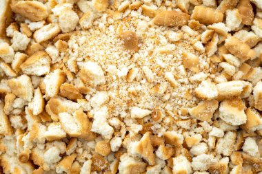 Close-up of a pile dried broken pieces of biscuit, heap of sweet bread crumbs, top vie