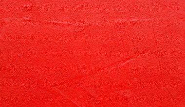 Part of wall with rough red paint on surface, as texture or background