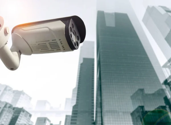 City security concept, CCTV camera in front of high tech business skyscrapers