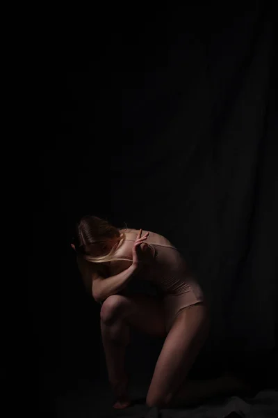 穿着米色紧身衣的芭蕾舞女 黑暗的背景雕刻的美丽的女性身体 体操运动员的皮球 — 图库照片