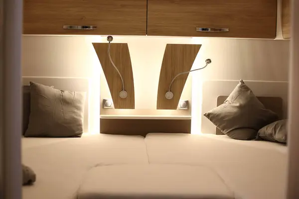Interior design of a bedroom  in a camper on wheels. Caravan, motorhome. Mobile home. Furniture