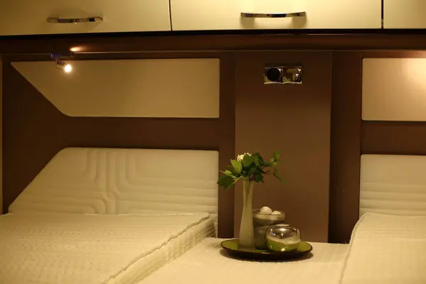 Interior design of a bedroom  in a camper on wheels. Caravan, motorhome. Mobile home. Furniture