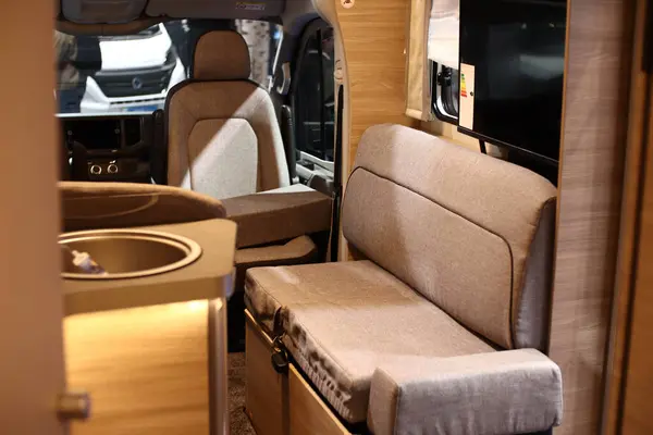 Interior design of a kitchen in a camper on wheels. Caravan, motorhome. Mobile home. Stove and furniture