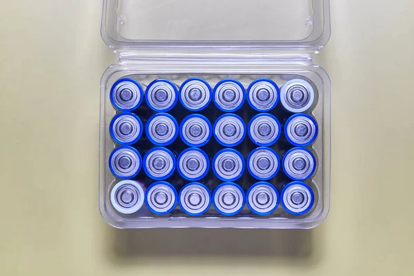 A box of blue plastic caps with the battery on it.