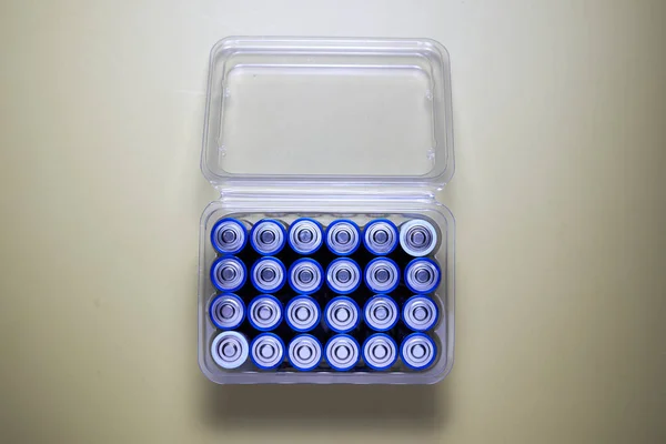 A box of blue plastic caps with the battery on it.