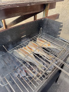 Izgara karides, karides şiş, Avrupa eritilmiş balık ve mısır koçanları yazın açık hava gıda pazarında ahşap kesme tahtasında: Kapatın. Barbekü, gastronomi, aşçılık, sokak yemekleri konsepti.