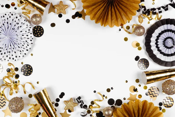 金と黒のコンフェッティ ノイズメーカー ストリーマーと装飾の大晦日のフレーム 白い背景の上の景色 — ストック写真