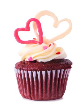 Valentines Day theme red velvet cupcake with candy hearts and butter cream icing. Side view isolated on a white background.