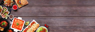 Healthy plant based vegetarian meal corner border. Top view on a dark wood banner background. Jackfruit tacos, zucchini lasagna, walnut bolognese zoodles, chickpea burgers, hummus, soups, salad.