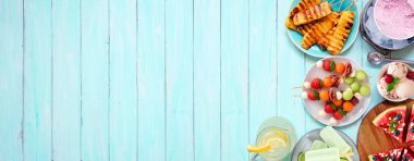 Yaz yemeği sınırını yeniliyorum. Izgara meyve, dondurma ve dondurma seçimi. Mavi ahşap bir arkaplanda üst görünüm.