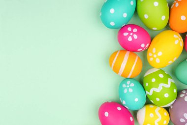 Yumuşak yeşil bir arka planda renkli Paskalya yumurtası kenarı. Boşluğu kopyala.