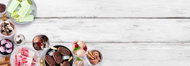 Serin yaz yemekleri köşe sınırı. Dondurma kaseleri, buzlu dondurmalar ve dondurulmuş ikramlar. Beyaz ahşap bir arka planda yukarıdan görüntü. Boşluğu kopyala.