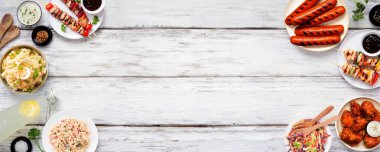 Summer BBQ food double border over a white wood banner background. Assorted grilled meats, salads and sides. Above view.