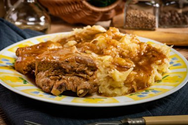 Soslu domuz pirzolası, lahana turşusu ve patates..