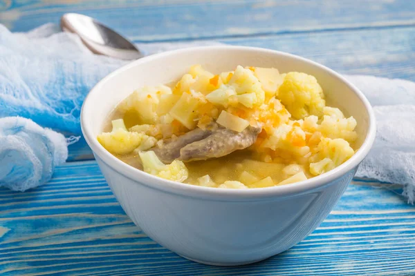 Ahşap masa üzerinde taze ev yapımı sebze çorbası.