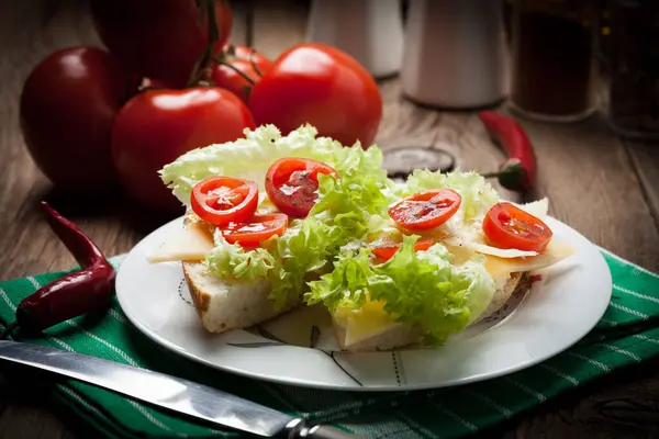 Fried toast sandwich with cheese, lettuce and tomatoes. Selective focus.
