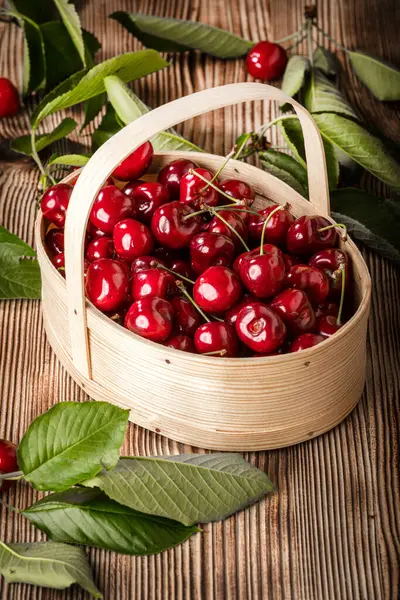 Sweet cherries in a wooden basket. Selective focus.