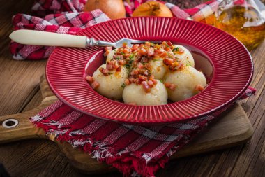 Pastırma, soğan ve bir plaka üzerinde ham patates köfte.