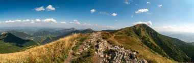 Hiking trail overlooking the mountain peaks of the hills. clipart