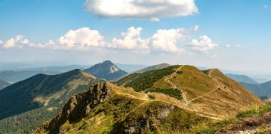 Hiking trail overlooking the mountain peaks of the hills. clipart