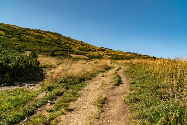 stock image Hiking trail overlooking the mountain peaks of the hills.