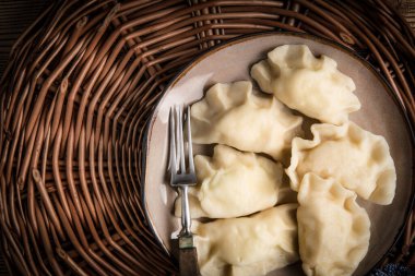 Homemade dumplings with cheese on a plate. Top view. clipart