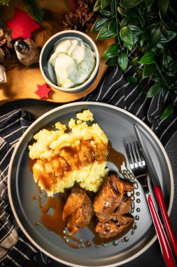 Sos ve patates püresiyle servis edilen haşlanmış hindi eti. Sığ alan derinliği.