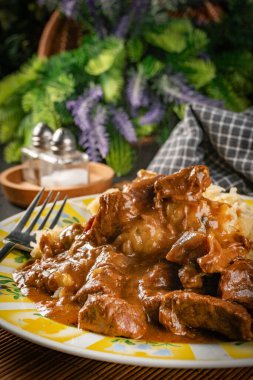 Lezzetli soslu sığır eti güveci, lahanayla servis edilir..