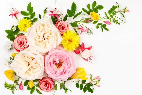 Flowers composition. Border of assorted fresh flowers and leaves on white background. Flat lay, top view with copy space.