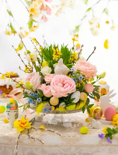 Easter still life with Flower composition and Traditional Easter treat on festive table decorated with spring flowers. Easter table.