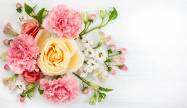 Güzel bahar çiçekleri Beyaz ahşap zemin üzerinde. Festival çiçek konsepti ile metin için temiz yer. Üstten görünüm.