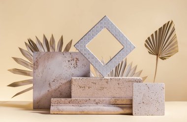 Abstract modern still life. Natural materials. Composition of palm leaves, travertine and concrete blocks.