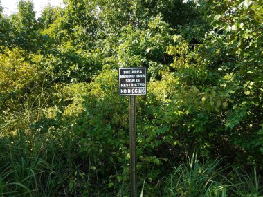 the area behind this sign is restricted no digging