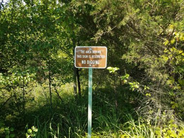 the area behind this sign is restricted no digging