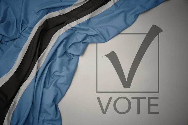 Махаючи Барвистим Національним Прапором Ботсвани Сірому Фоні Текстовим Голосуванням Концепція — стокове фото