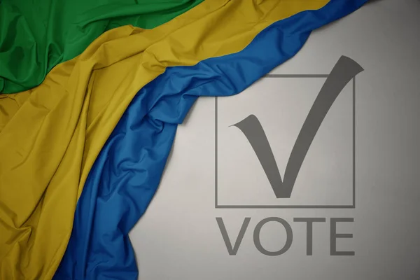 Színes Gaboni Nemzeti Zászlót Lobogtatva Szürke Háttérrel Szöveges Szavazással Választási — Stock Fotó