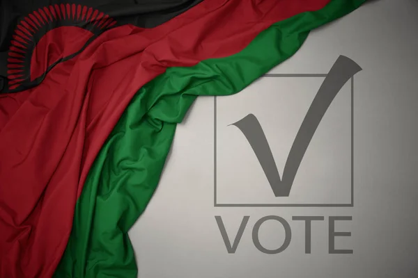 Махаючи Барвистим Національним Прапором Малаві Сірому Фоні Текстовим Голосуванням Концепція — стокове фото