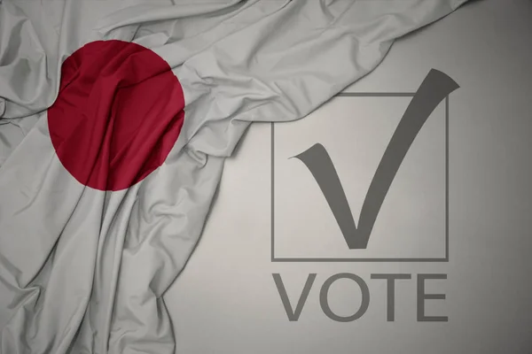 Machanie Kolorową Flagą Japonii Szarym Tle Głosowaniem Tekstowym Koncepcja Wyborów — Zdjęcie stockowe