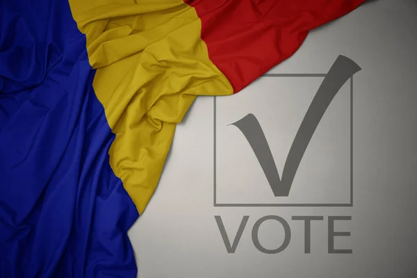 Machanie Kolorową Flagą Narodową Rumunii Szarym Tle Głosowaniem Tekstowym Koncepcja — Zdjęcie stockowe