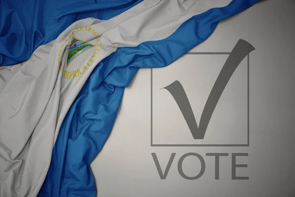 Ondeando Colorida Bandera Nacional Nicaragua Sobre Fondo Gris Con Voto —  Fotos de Stock